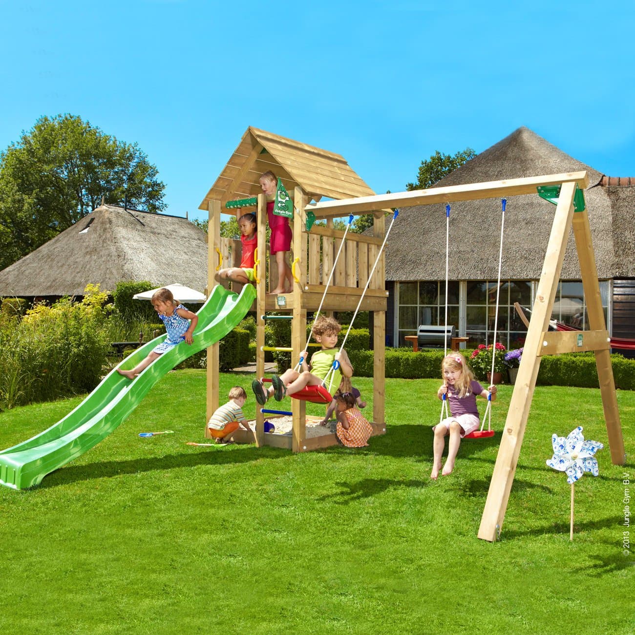 Outdoor Play Centre. Jungle Gym Cabin + Swing Module - Strong, Long-Lasting Wooden Activity Centre with Swingset, Slide and Sandpit makes a Great Adventure Playground. This Outdoor Playhouse and Playset is Perfect for Kids Garden Games and Parties.