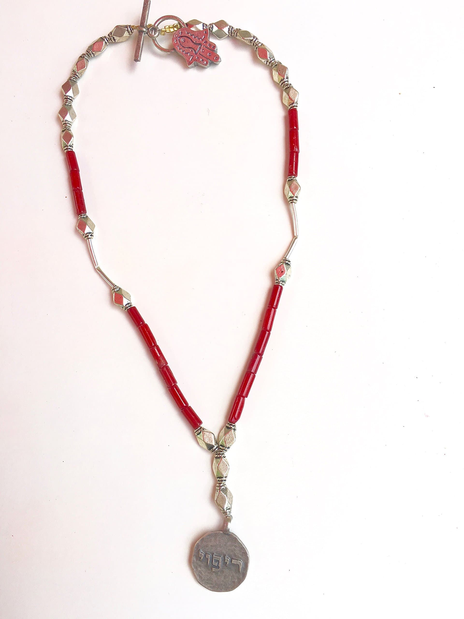 RED CORAL NECKLACE WITH A KABBALAH PENDANT WITH A HEBREW INSCRIPTION FOR GOOD HEALTH AND PROSPERITY.