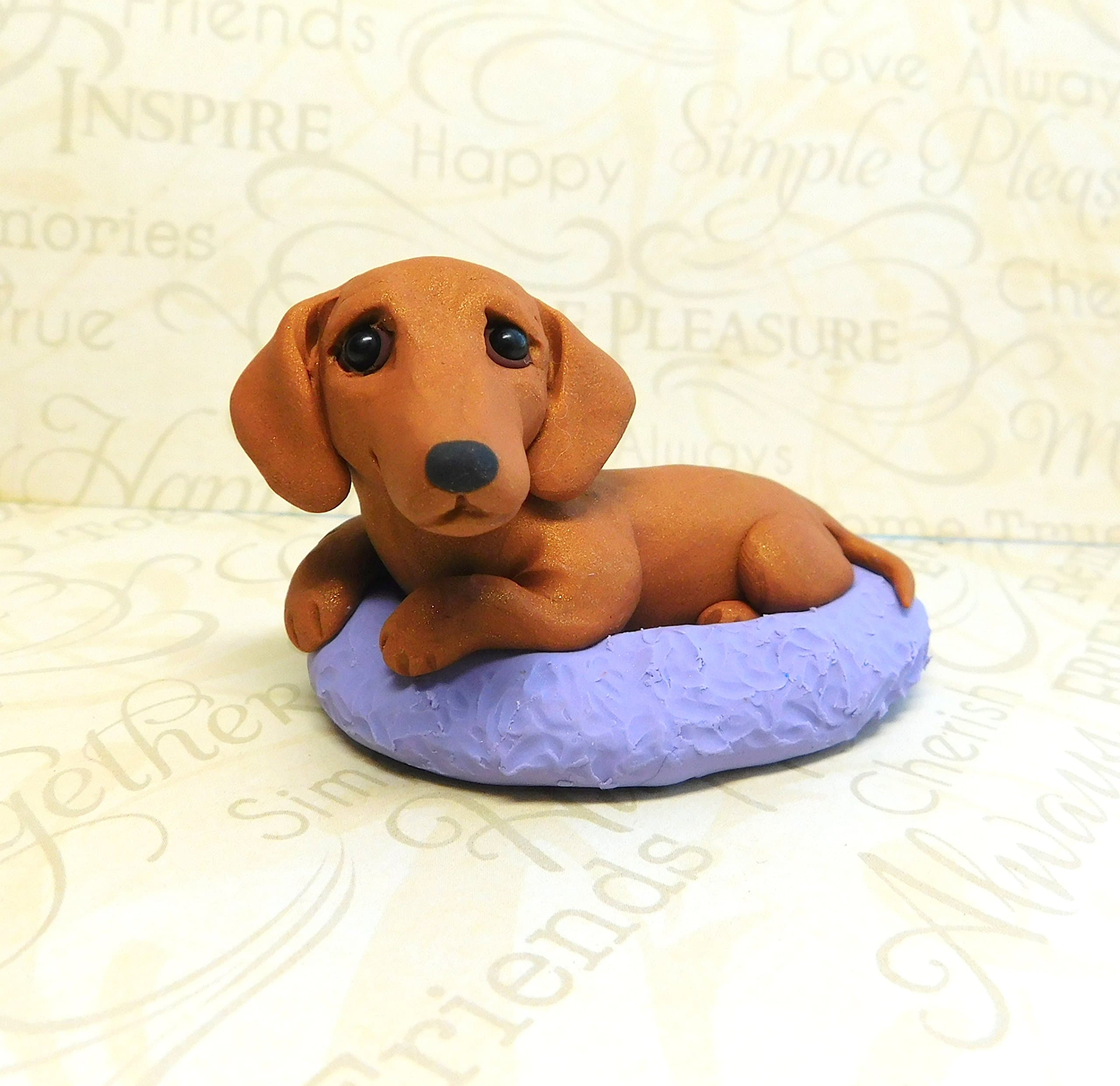 Dachshund in dog bed polymer clayn Doxie sculpture by Raquel at the WRC dog collectible